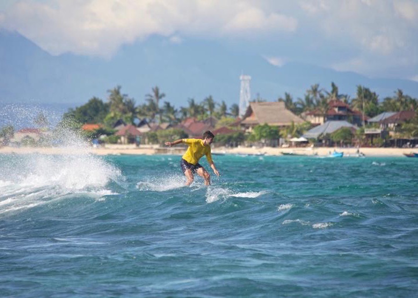 Surfer riding the waves in Nusa Lembongan, Bali, Indonesia