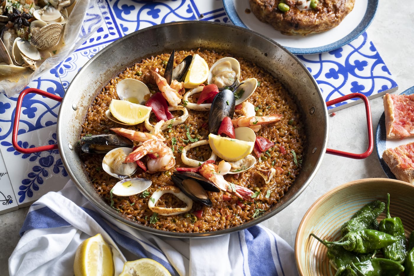 a big plate of paella with various seafoods
