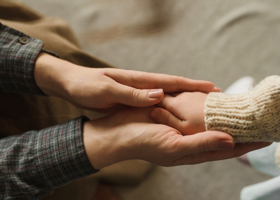 mother holding a child's hand custody parenting