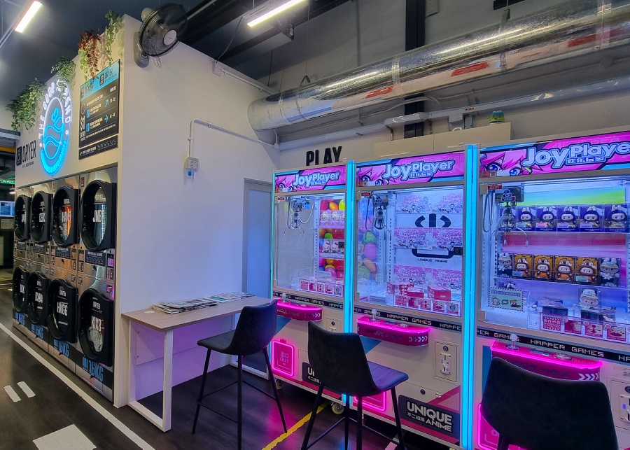 Claw machines beside dryers at The Good Husband Laundromats & Drycleaners | Cool laundromats in Singapore